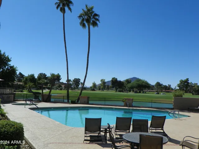 a view of a lake with a table and chairs