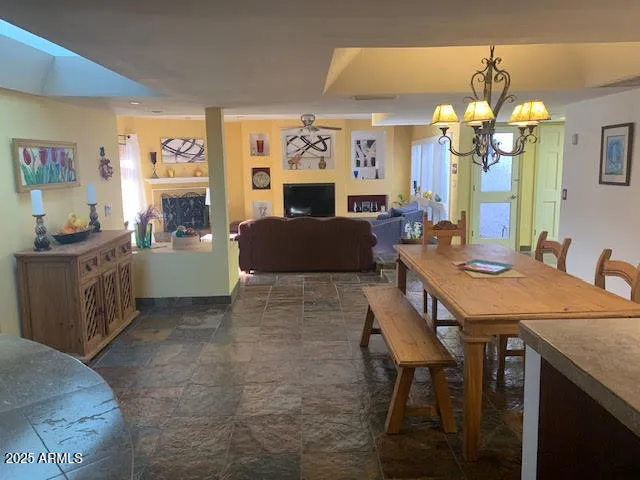 a view of a dining room with furniture and chandelier