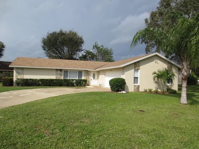 a front view of house with yard and trees
