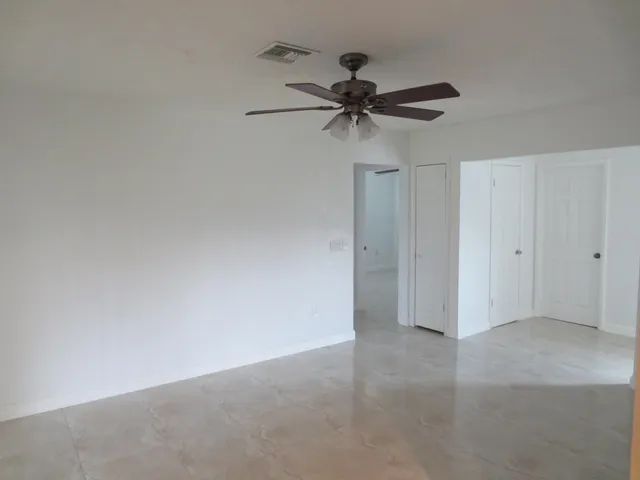 a view of a big room with a chandelier fan