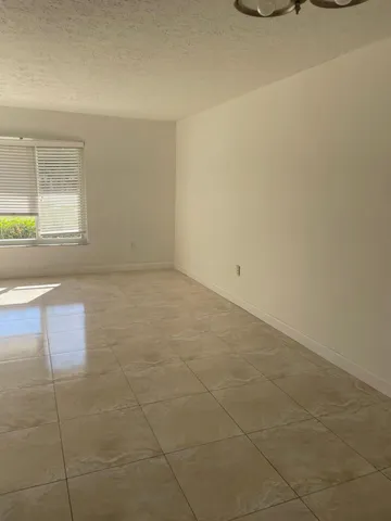 a view of a livingroom with an empty space and window