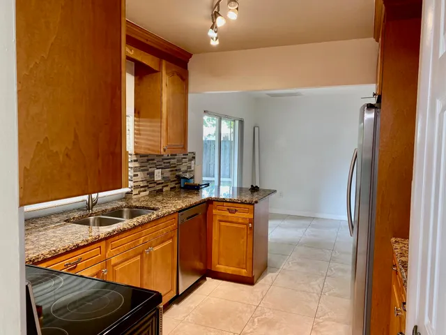 a kitchen with a sink and a refrigerator
