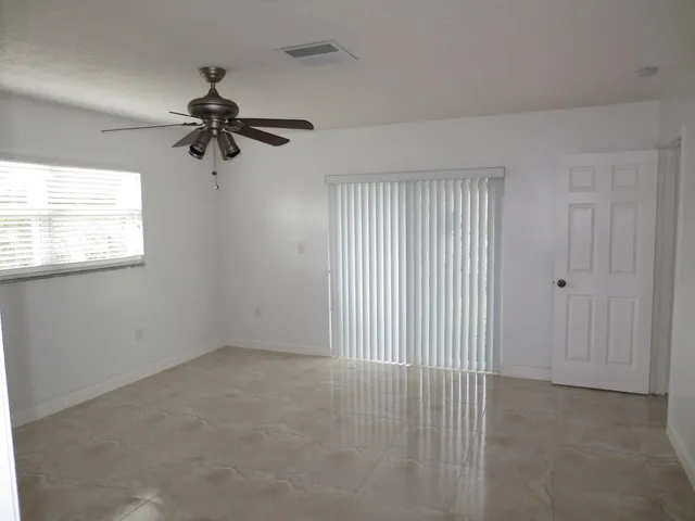 a view of room window and a ceiling fan