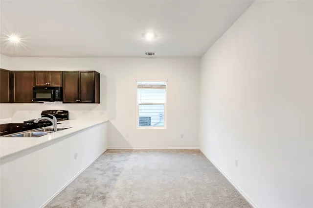 a kitchen with a refrigerator stove and microwave