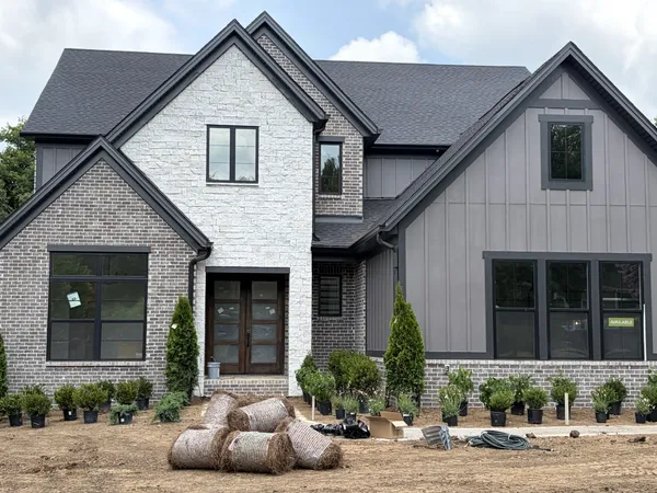 a front view of a house with a yard