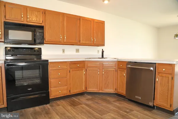 a kitchen with a refrigerator stove and sink