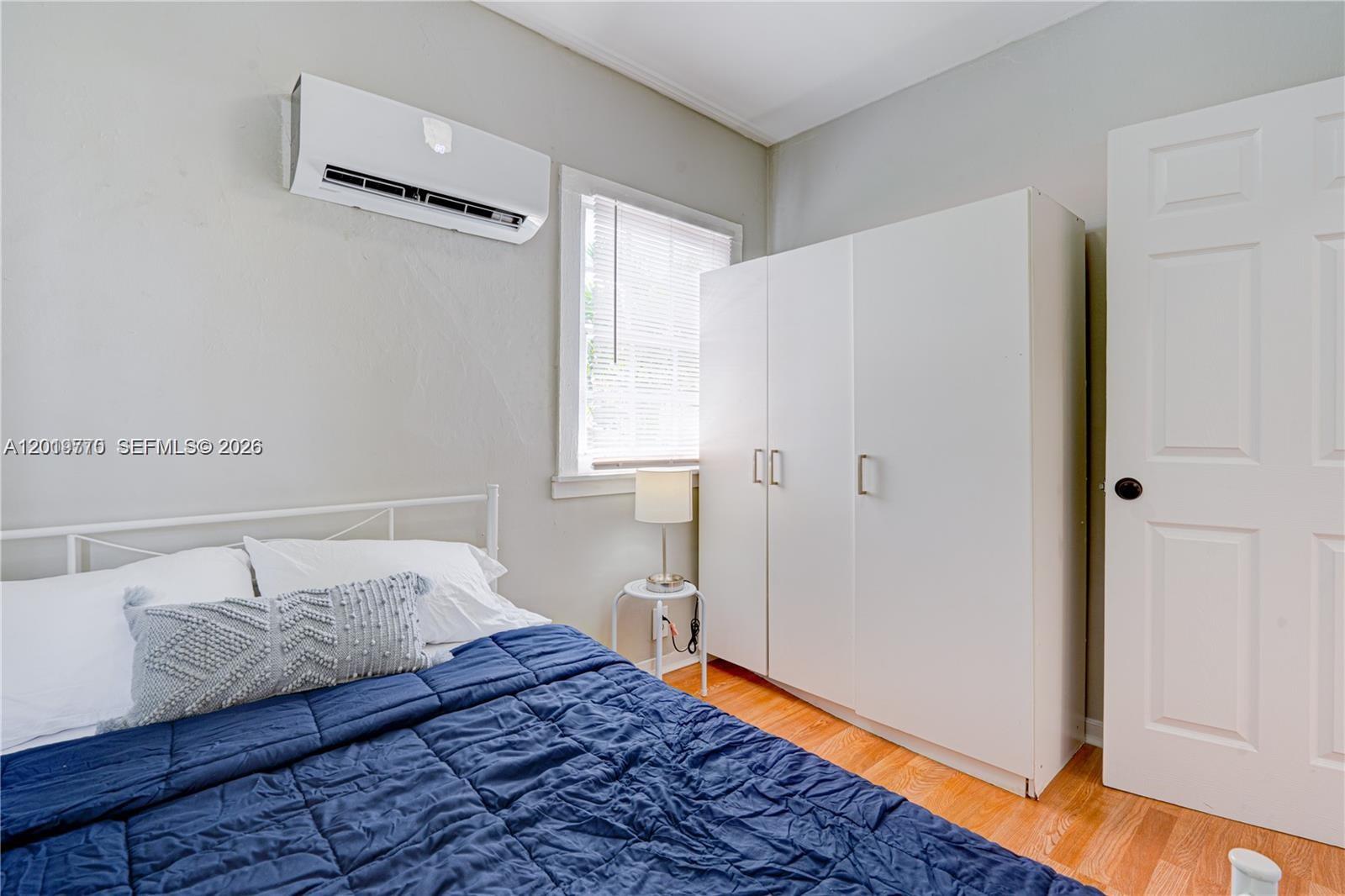 227 Southwest 30th Avenue, Unit B Miami, FL 33135 - Photo 11 of 15 a bedroom with a bed and a window