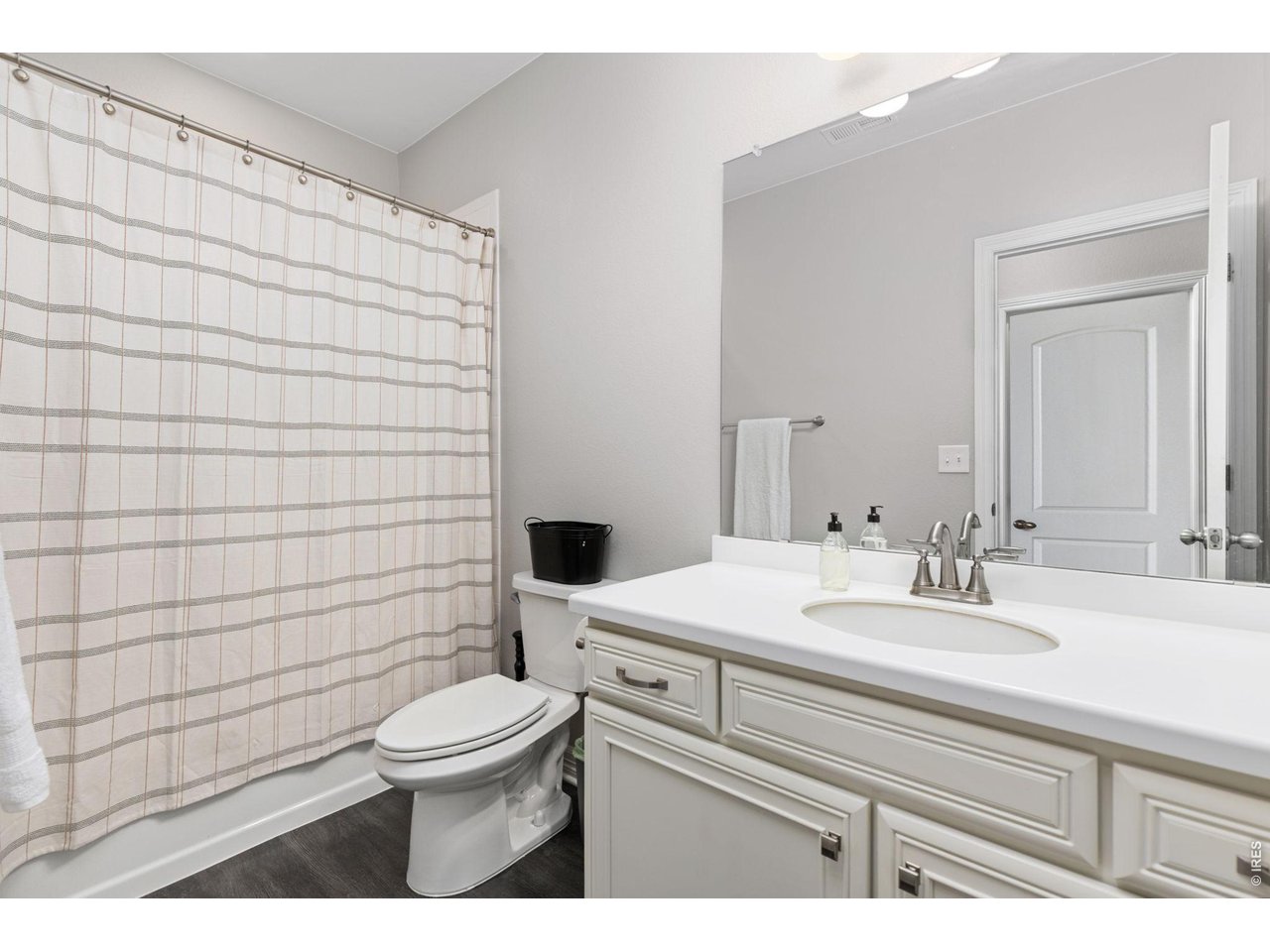1122 Gabriella Lane Berthoud, CO 80513 - Photo 22 of 33 a bathroom with a sink a toilet and mirror