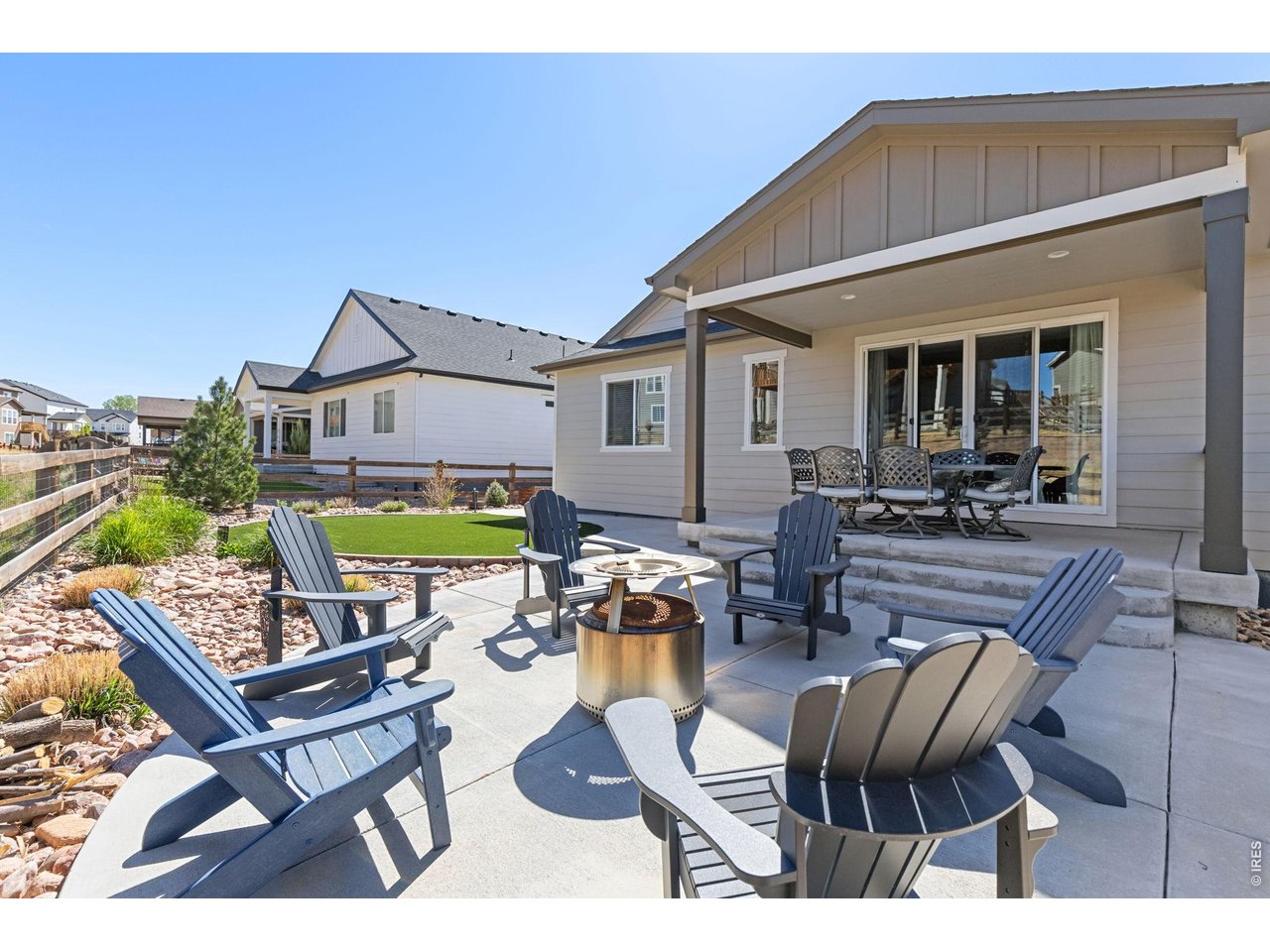 1122 Gabriella Lane Berthoud, CO 80513 - Photo 27 of 33 a view of a patio with a dining table and chairs with wooden floor