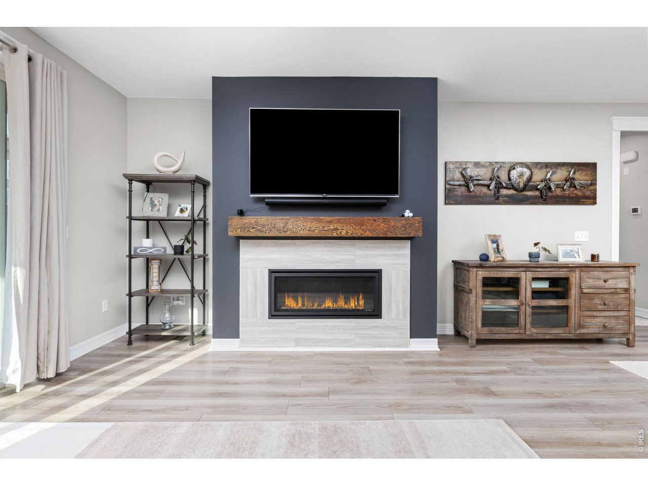 1122 Gabriella Lane Berthoud, CO 80513 - Photo 9 of 33 a living room with a flat screen tv and a fireplace