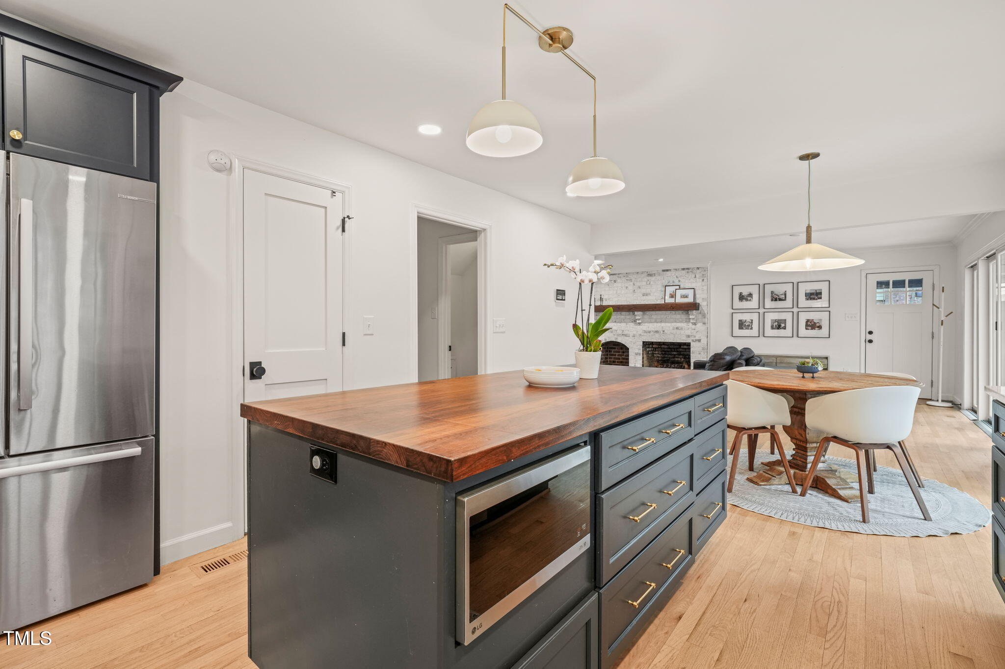 4714 Highgate Drive Durham, NC 27713 - Photo 15 of 50 a kitchen with a table chairs refrigerator and wooden floor