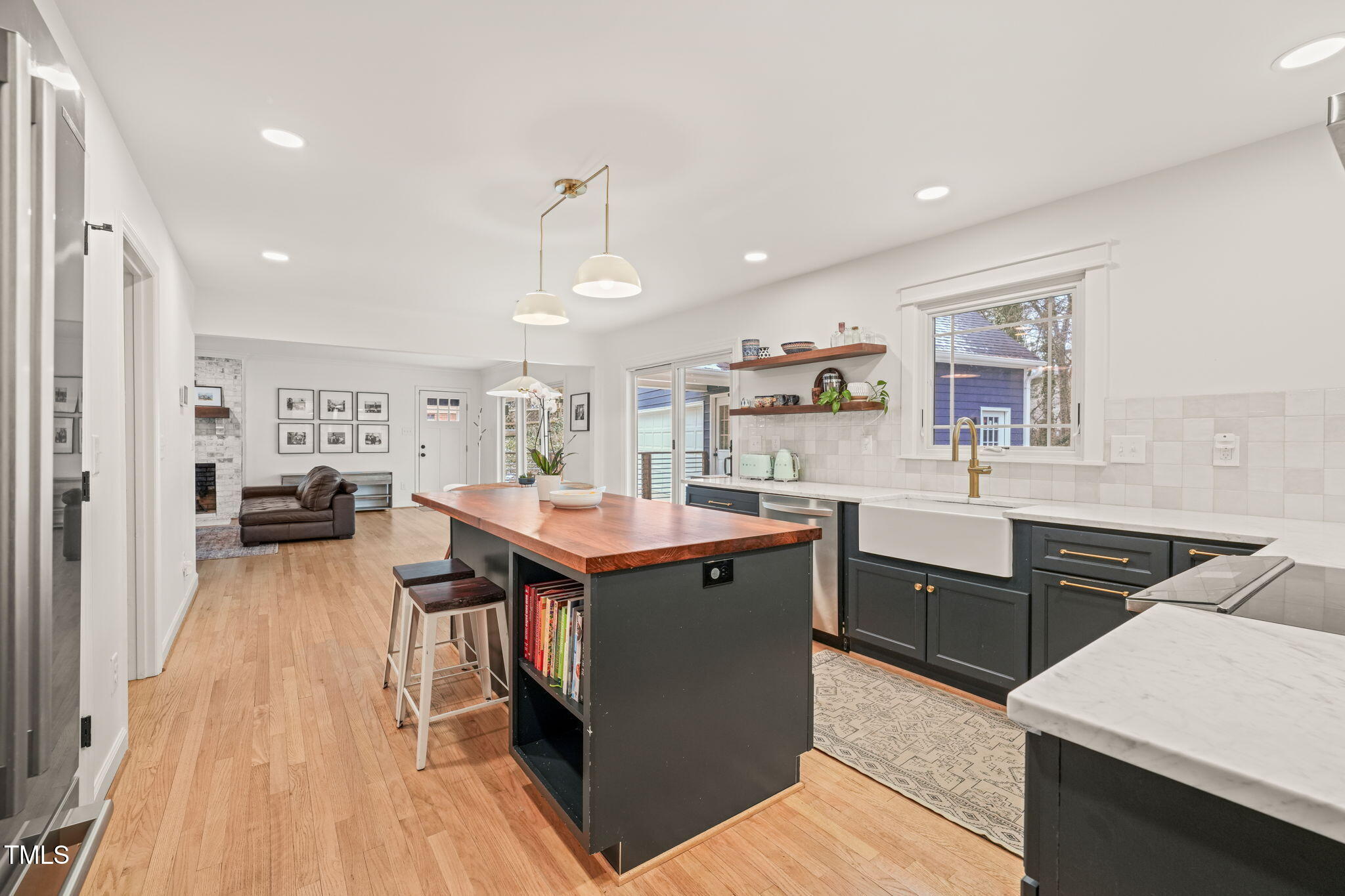 4714 Highgate Drive Durham, NC 27713 - Photo 21 of 50 a kitchen with a sink a counter top space and stainless steel appliances