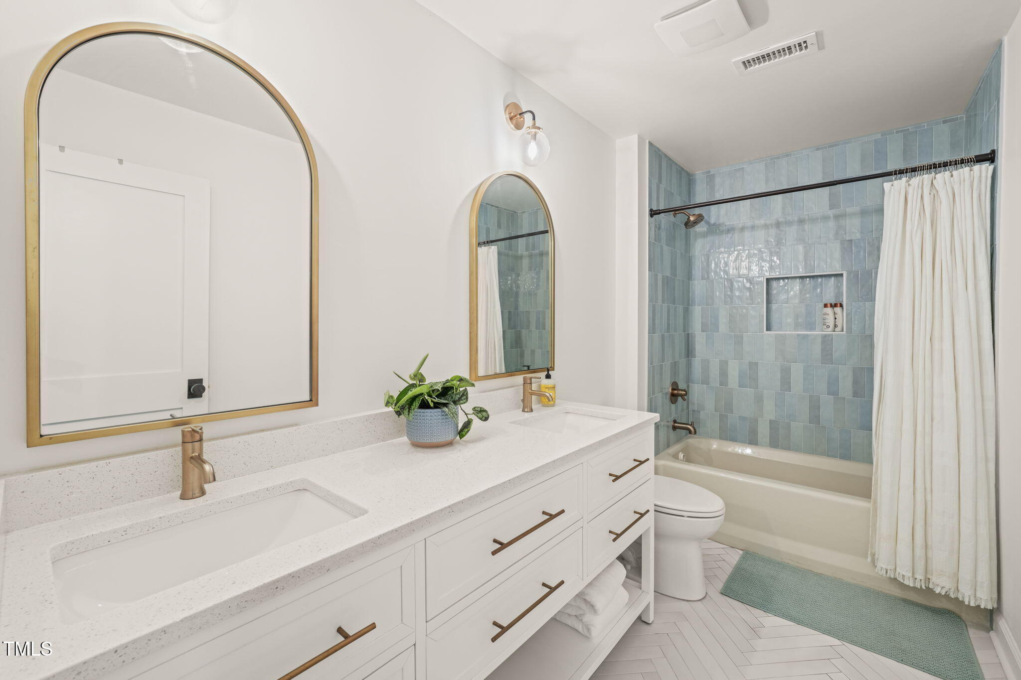 4714 Highgate Drive Durham, NC 27713 - Photo 33 of 50 a bathroom with a sink a toilet and tub