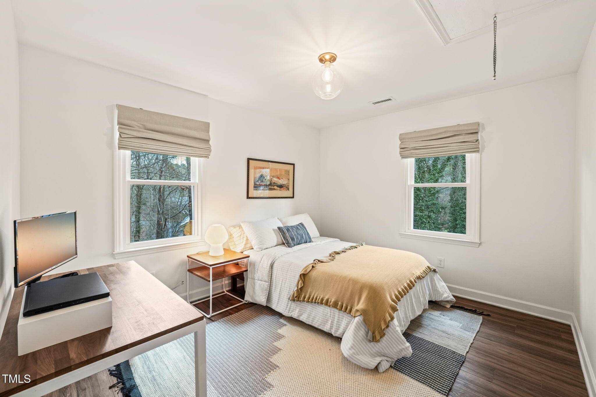 4714 Highgate Drive Durham, NC 27713 - Photo 36 of 50 a bedroom with a bed and a flat screen tv