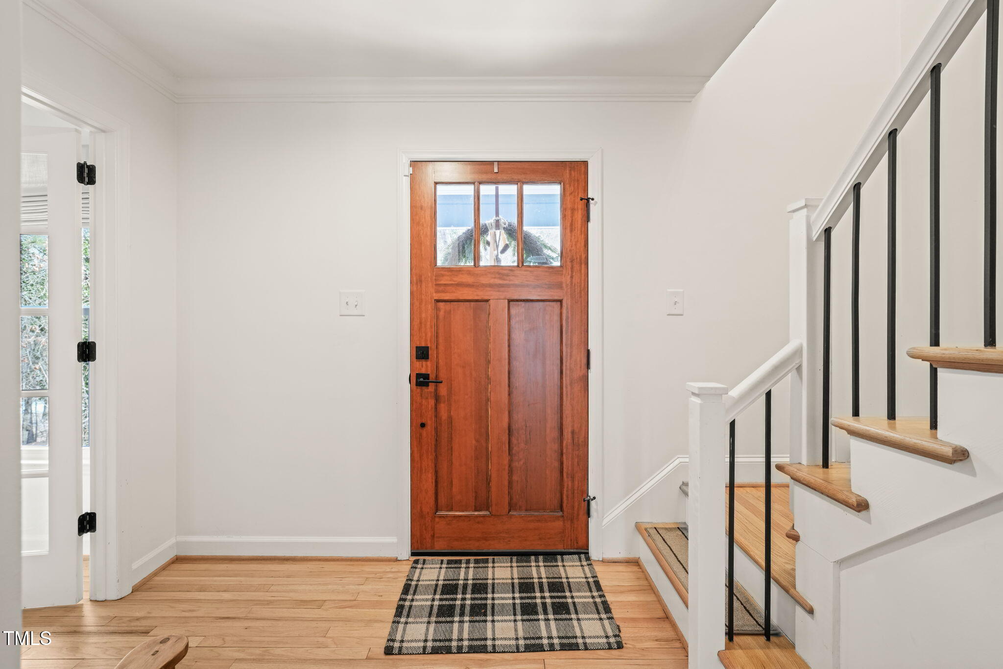 4714 Highgate Drive Durham, NC 27713 - Photo 3 of 50 a view of a hallway with wooden floor and stairs