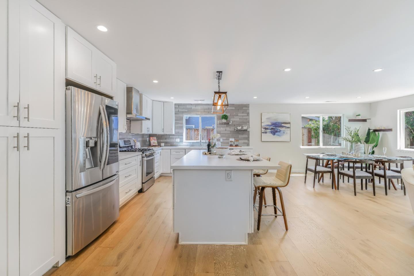 1120 Springfield Drive Campbell, CA 95008 - Photo 34 of 48 a kitchen with stainless steel appliances kitchen island granite countertop a refrigerator a stove a sink a dining table and chairs with wooden floor