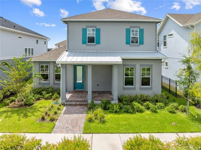 a view of a house with brick walls plants and large windows