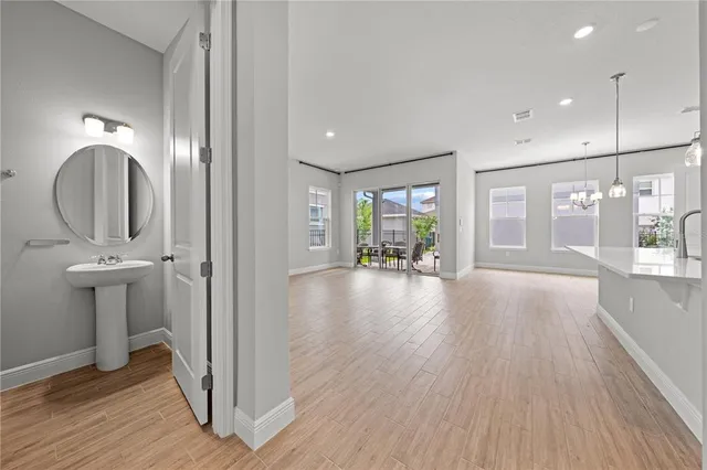 a kitchen with stainless steel appliances granite countertop a stove a sink a refrigerator and a wooden cabinets