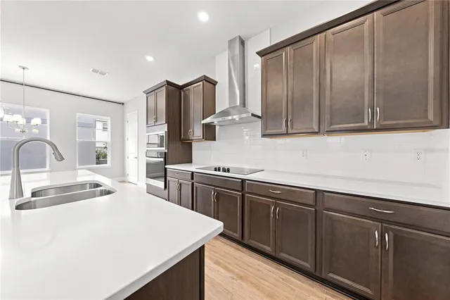 a view of an empty room with wooden floor and window