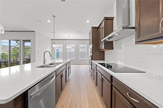 a spacious bathroom with a double vanity sink a large mirror a shower and a