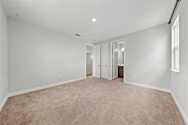 a view of a house with swimming pool and sitting area