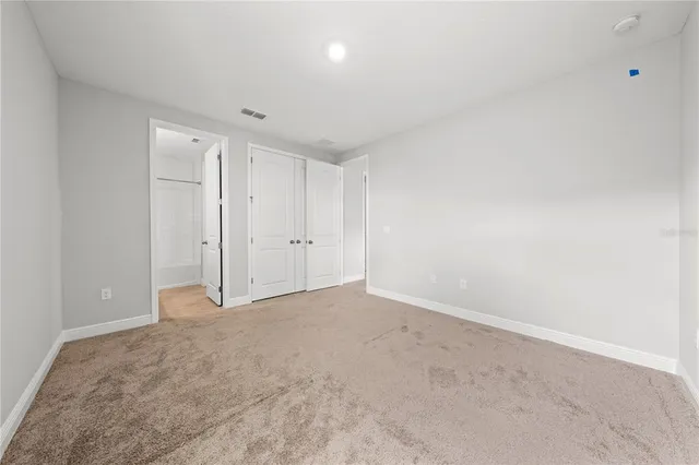 an aerial view of residential houses with open space and parking