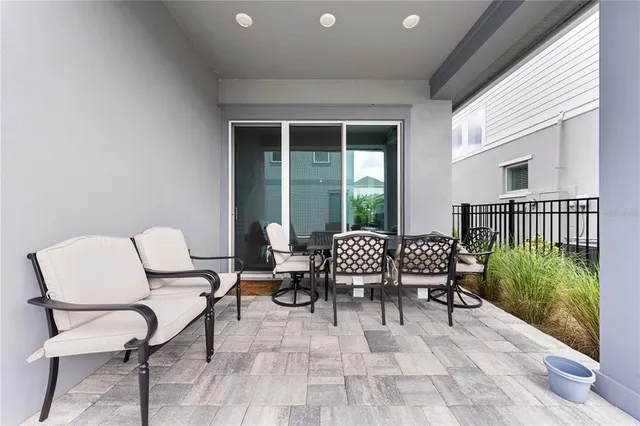 an aerial view of residential houses with outdoor space and trees