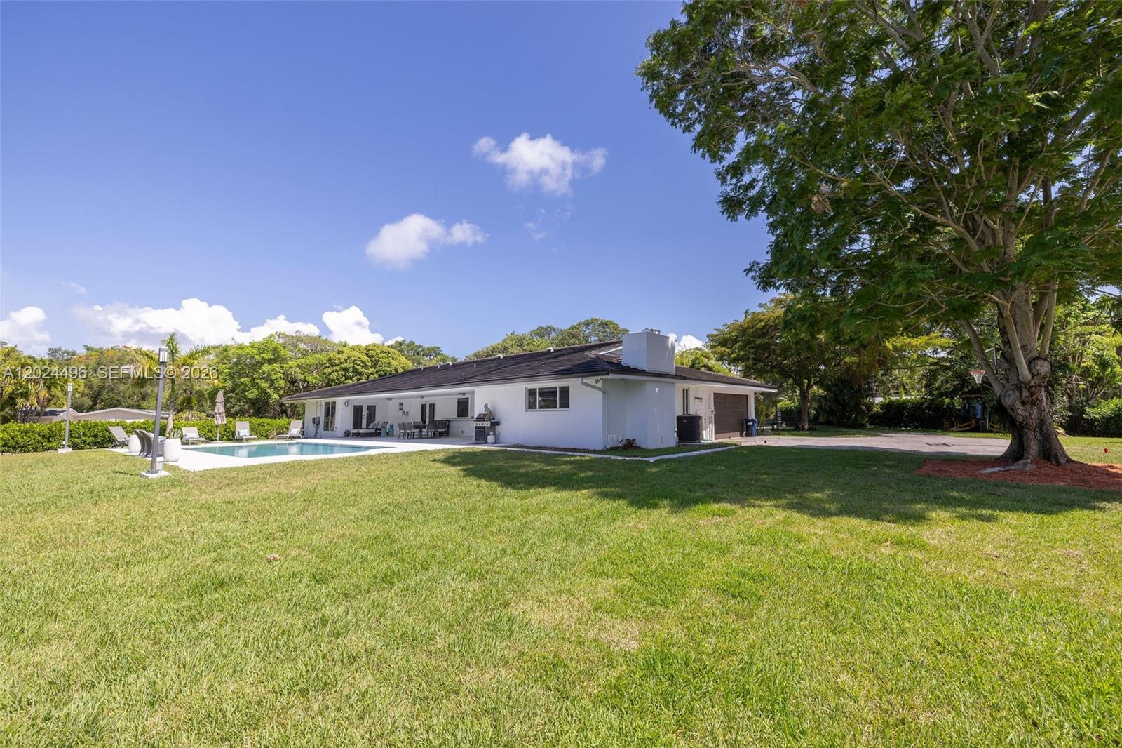 6875 North Cartee Road Palmetto Bay, FL 33158 - Photo 38 of 42 a view of a house with pool and a yard