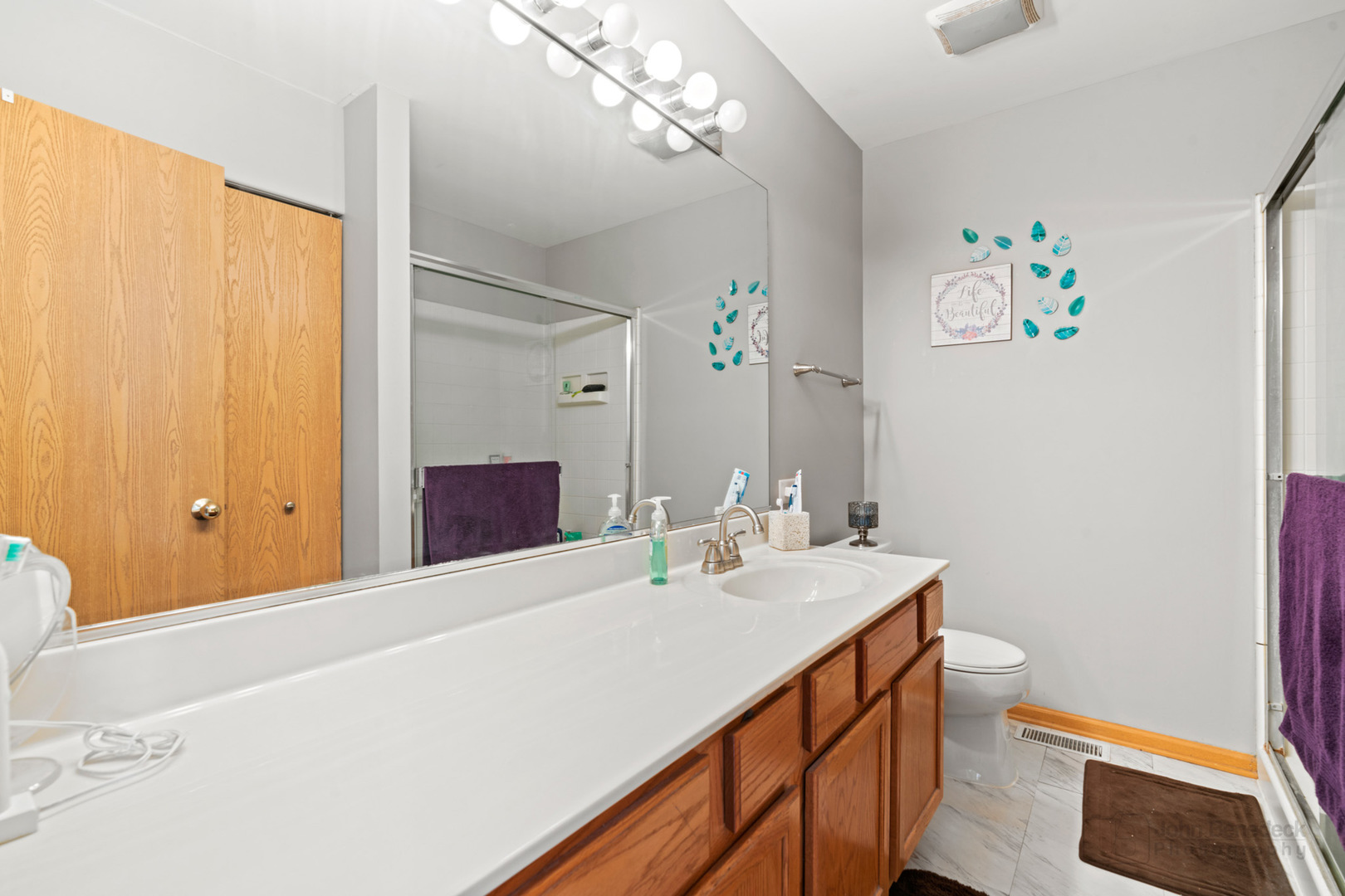 1106 Delta Drive Elgin, IL 60123 - Photo 15 of 26 a bathroom with a sink a toilet and a mirror