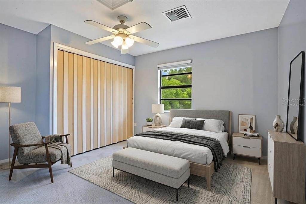 5785 Gilliam Road Orlando, FL 32818 - Photo 70 of 100 a bedroom with a bed and a chandelier