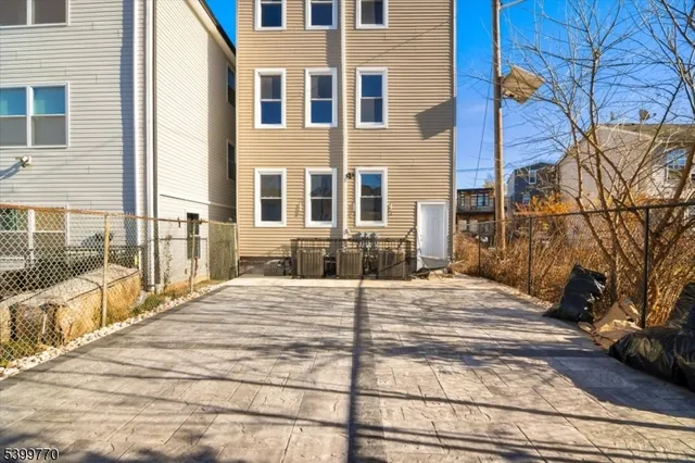a front view of a house with a road