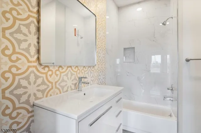 a bathroom with a bathtub and shower