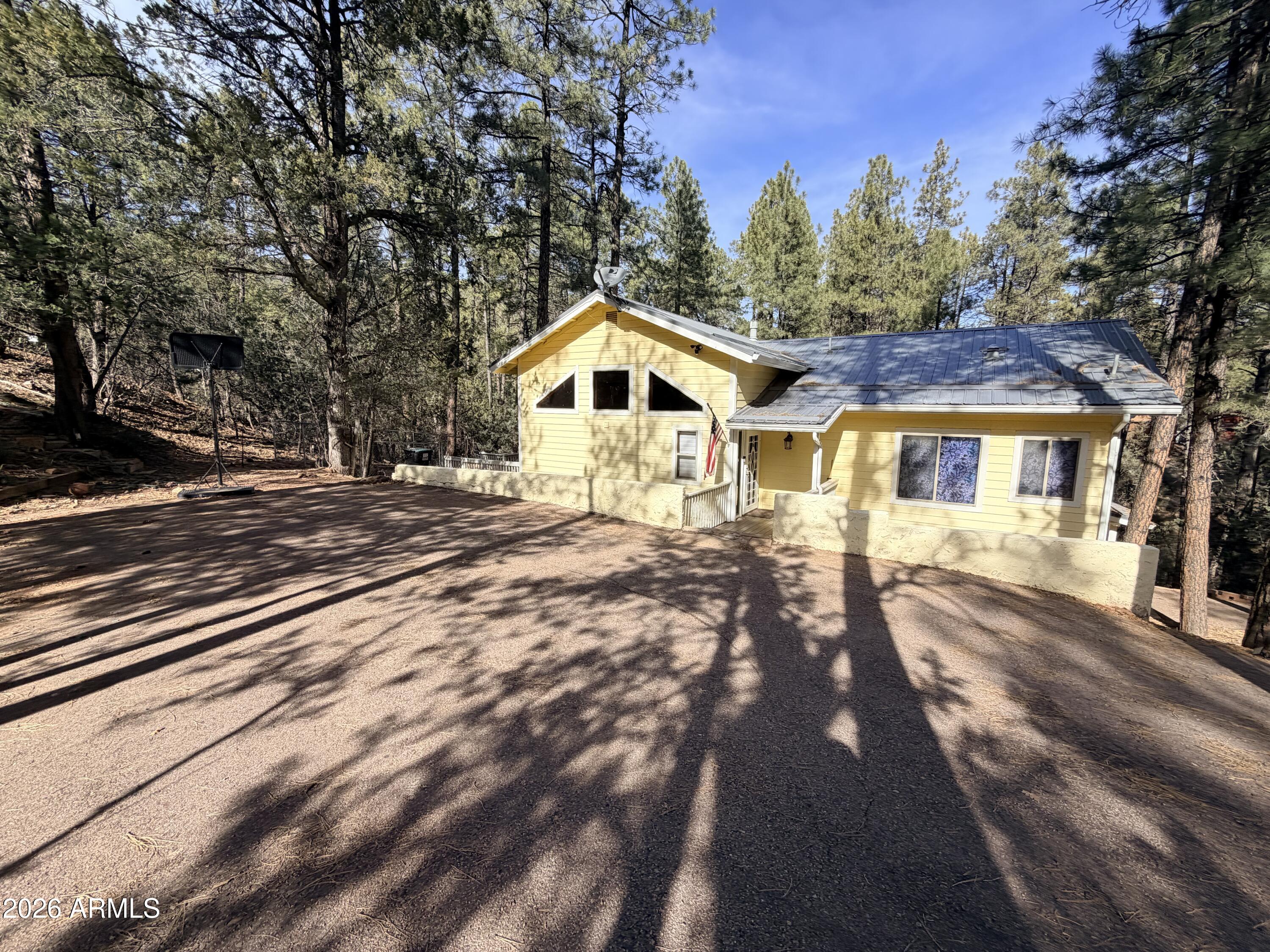 6870 Robbin Lane Pine, AZ 85544 - Photo 1 of 37 a front view of a house with a yard