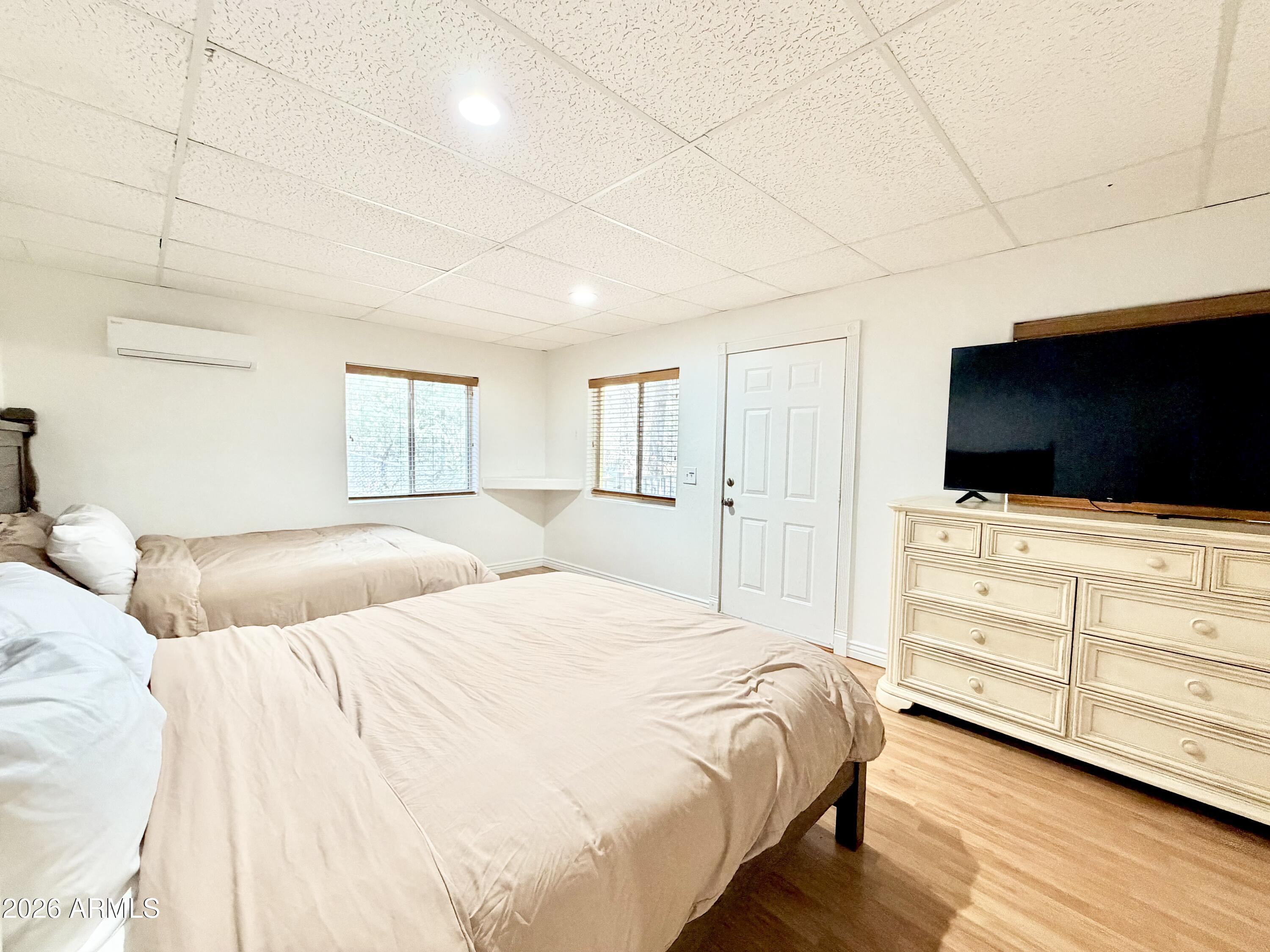 6870 Robbin Lane Pine, AZ 85544 - Photo 16 of 37 a bedroom with a bed and a flat screen tv in the kitchen