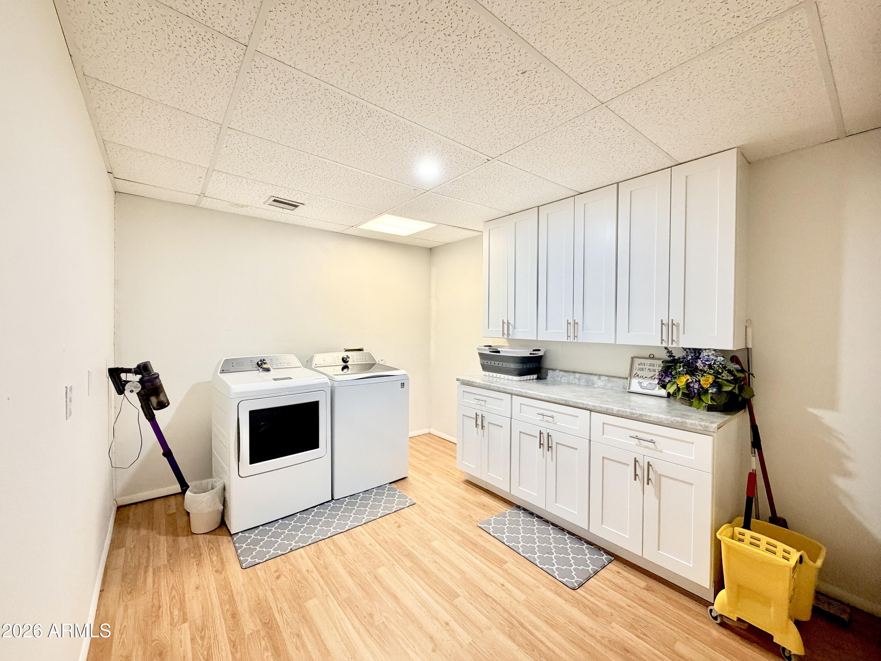 6870 Robbin Lane Pine, AZ 85544 - Photo 20 of 37 a kitchen with a sink and white cabinets with wooden floor