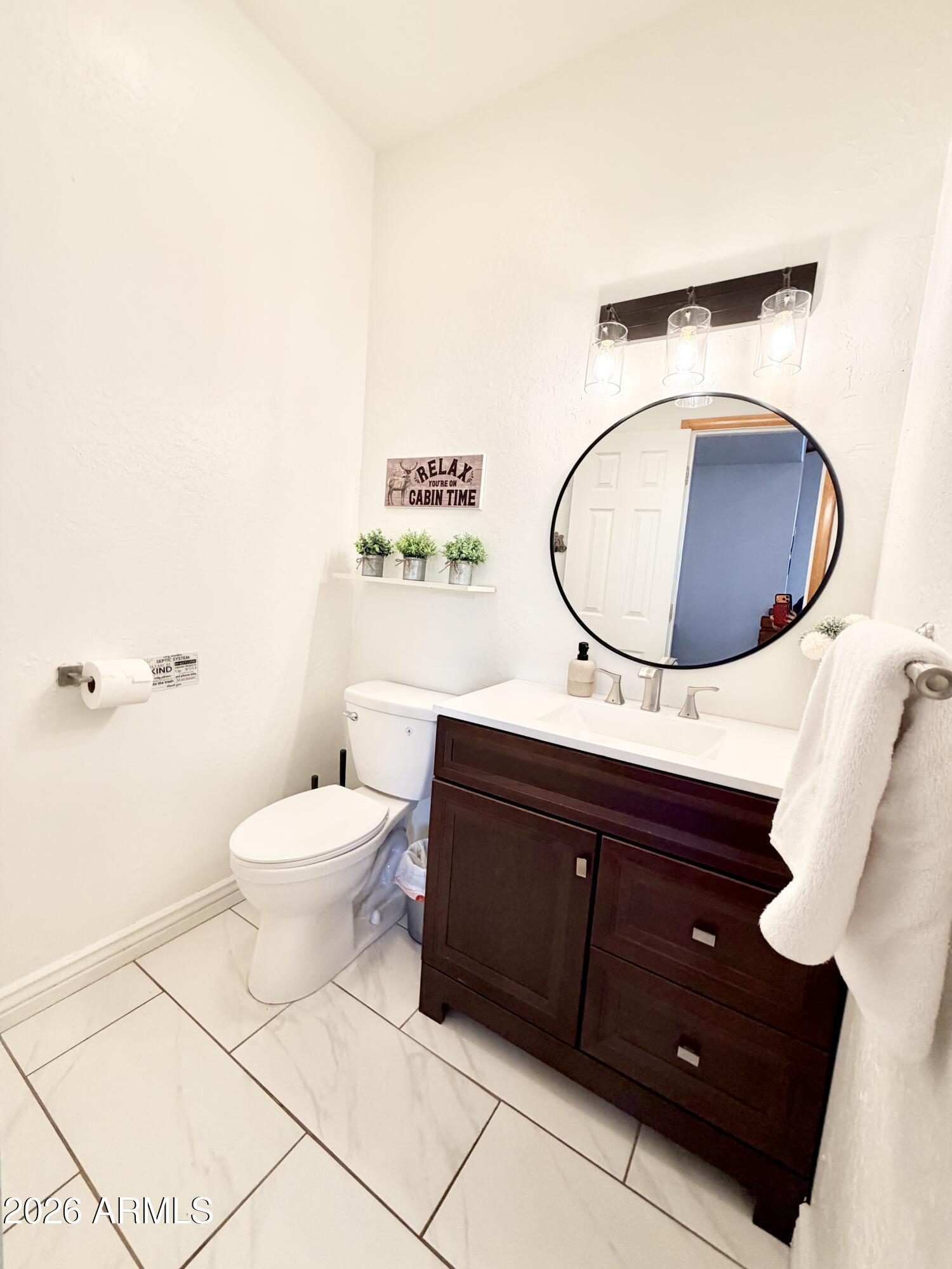 6870 Robbin Lane Pine, AZ 85544 - Photo 8 of 37 a bathroom with a toilet a sink and mirror