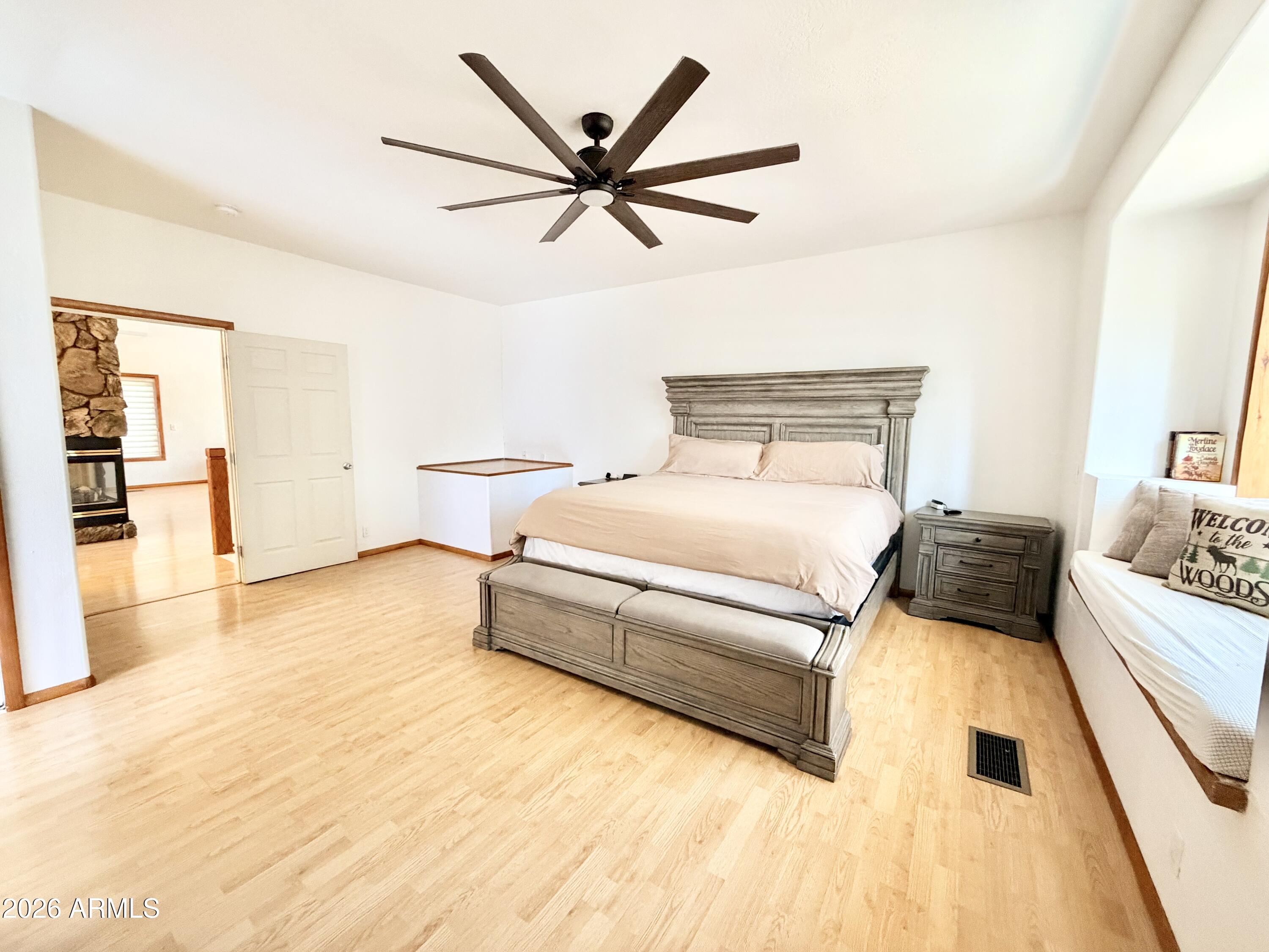 6870 Robbin Lane Pine, AZ 85544 - Photo 10 of 37 a bed room with a bed and a chandelier