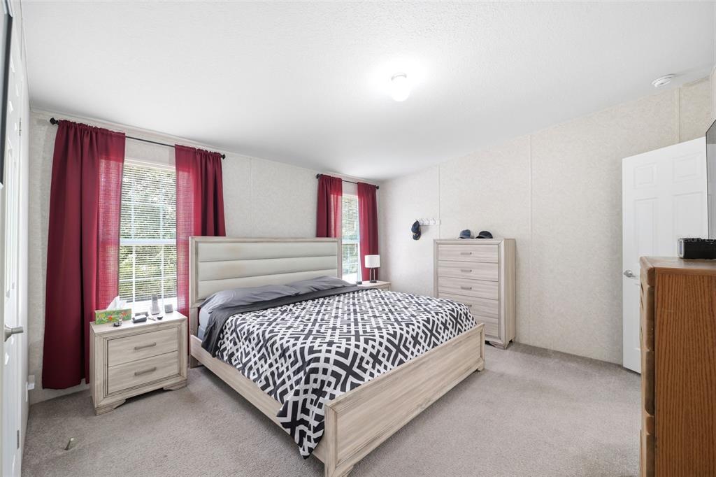 3183 Cedley Road Dade City, FL 33523 - Photo 13 of 48 a bedroom with a bed and a window
