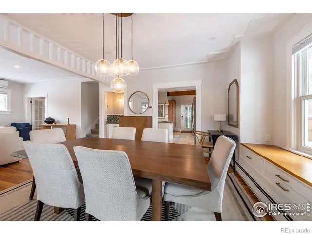 a view of a dining room with furniture and a chandelier