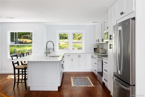 a kitchen with a sink stove and refrigerator