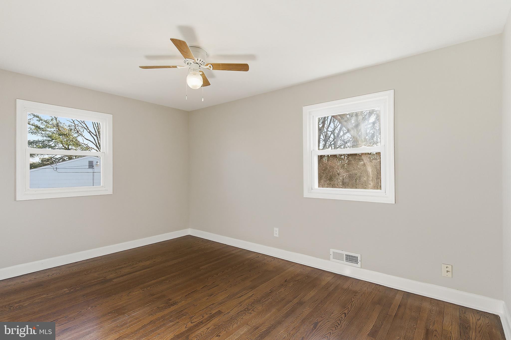 183 Jordan Road Somers Point, NJ 08244 - Photo 27 of 40 a view of an empty room with wooden floor and a ceiling fan