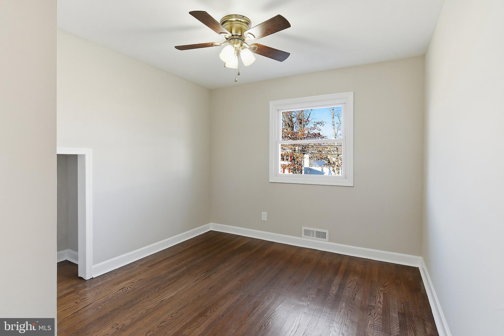 183 Jordan Road Somers Point, NJ 08244 - Photo 28 of 40 an empty room with wooden floor and ceiling fan