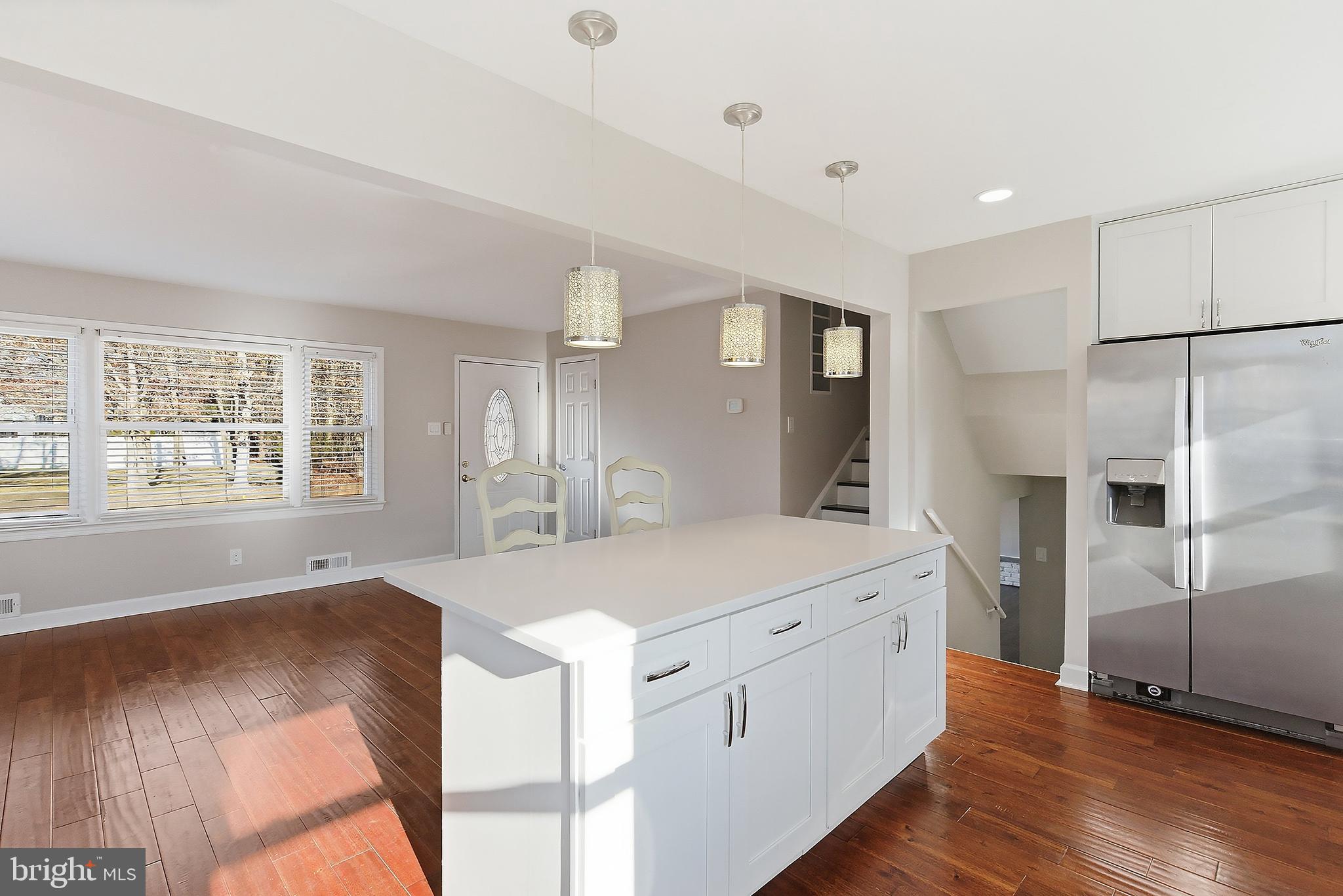 183 Jordan Road Somers Point, NJ 08244 - Photo 9 of 40 a large white kitchen with a refrigerator a sink dishwasher and a stove with wooden floor