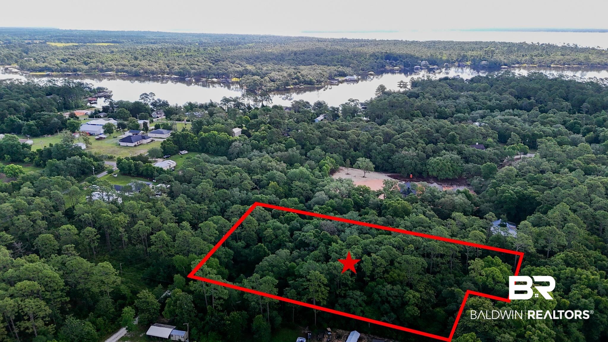 30678 Forgotten Lane Elberta, AL 36530 - Photo 2 of 5 Aerial view of property's location featuring a heavily wooded area, a nearby body of water, and property boundaries highlighted