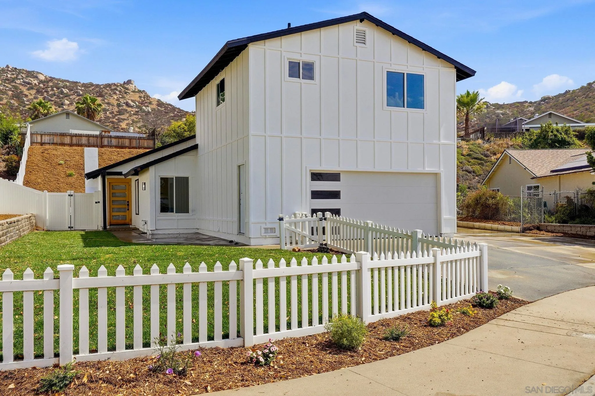 10440 Bosque Drive Lakeside, CA 92040 - Photo 4 of 47 a front view of a house with a garden