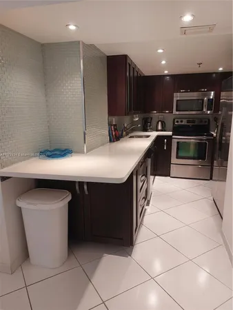 a kitchen with a stove and a microwave