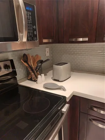 a kitchen with stainless steel appliances a refrigerator and a sink