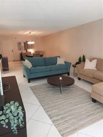a view of a dining room with furniture and a chandelier