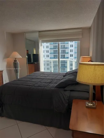 a bedroom with a bed and a lamp