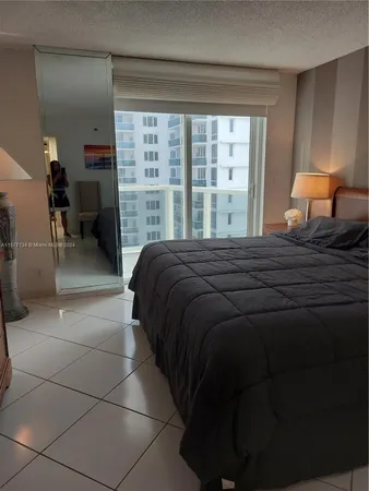 a bedroom with a bed and a lamp